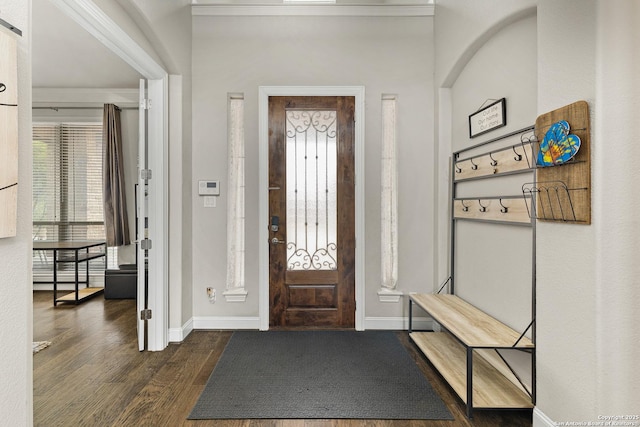 entryway with dark wood-style floors and baseboards