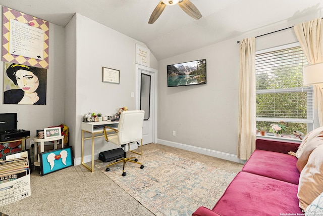 carpeted office space with ceiling fan, vaulted ceiling, and baseboards