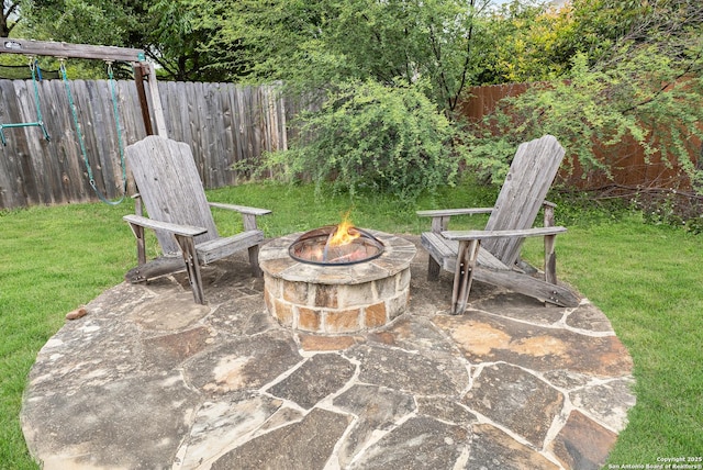 view of patio / terrace with fence and an outdoor fire pit