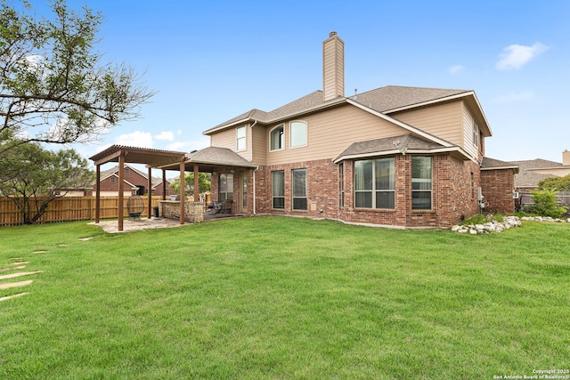 back of house with a patio, a yard, brick siding, a gazebo, and fence