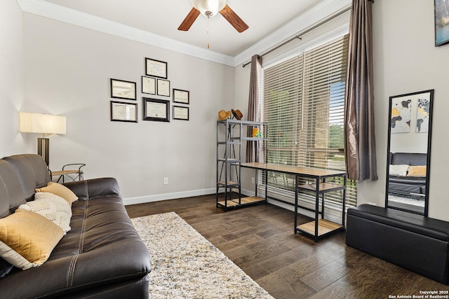 living area featuring crown molding, dark wood-style floors, ceiling fan, and baseboards