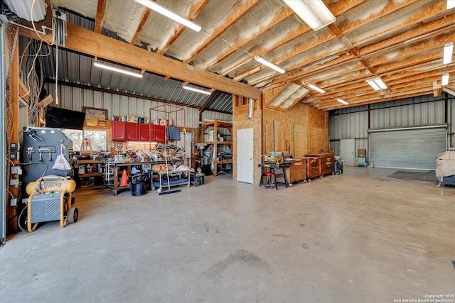garage with a workshop area and metal wall