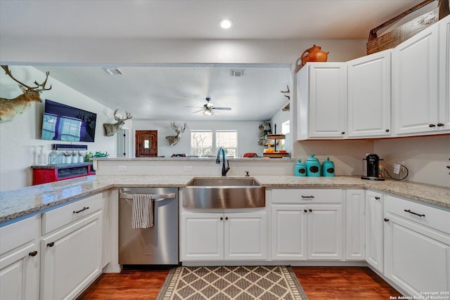 kitchen with wood finished floors, stainless steel dishwasher, ceiling fan, a sink, and visible vents