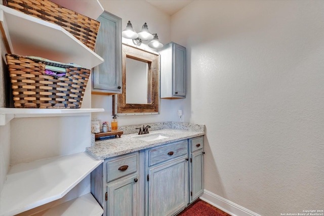 bathroom with vanity and baseboards