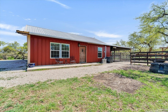 exterior space with cooling unit, an exterior structure, and an outbuilding