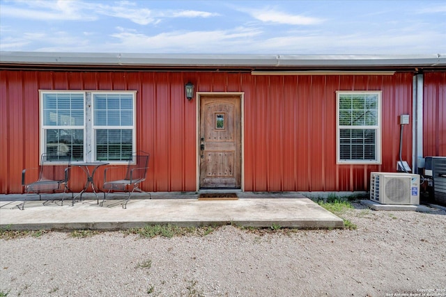 doorway to property featuring a patio and ac unit