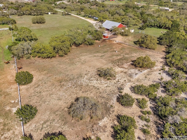birds eye view of property with a rural view