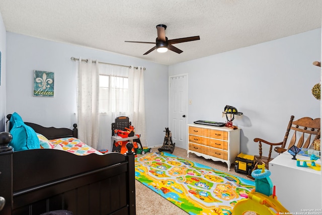 bedroom with ceiling fan, a textured ceiling, and carpet