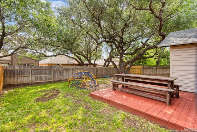view of yard with a fenced backyard and a wooden deck