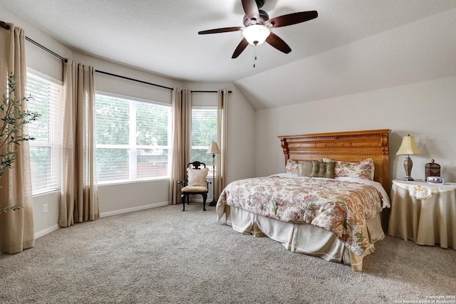 carpeted bedroom with baseboards, ceiling fan, and lofted ceiling