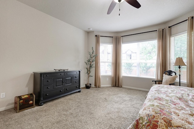 carpeted bedroom featuring baseboards and ceiling fan