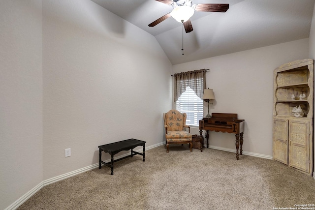sitting room featuring a ceiling fan, light colored carpet, vaulted ceiling, and baseboards