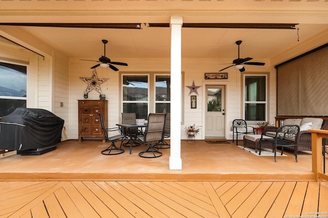 wooden deck with a ceiling fan, outdoor dining area, area for grilling, and outdoor lounge area