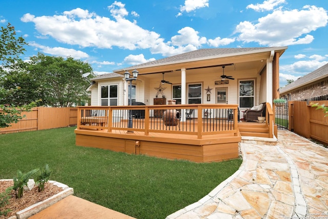 rear view of house featuring a lawn, ceiling fan, a shingled roof, and a fenced backyard
