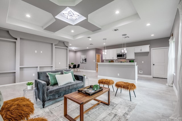 living room with visible vents, coffered ceiling, baseboards, recessed lighting, and built in features