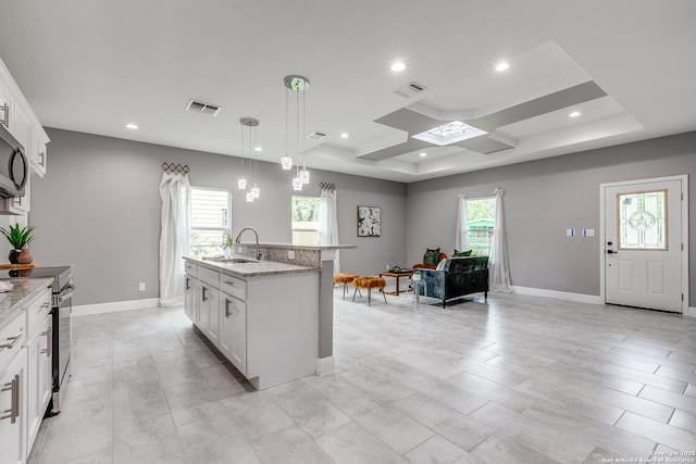 kitchen featuring visible vents, range with electric cooktop, light stone countertops, and a sink