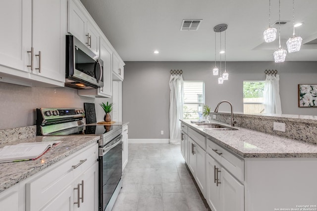 kitchen with white cabinetry, a sink, visible vents, stainless steel appliances, and recessed lighting