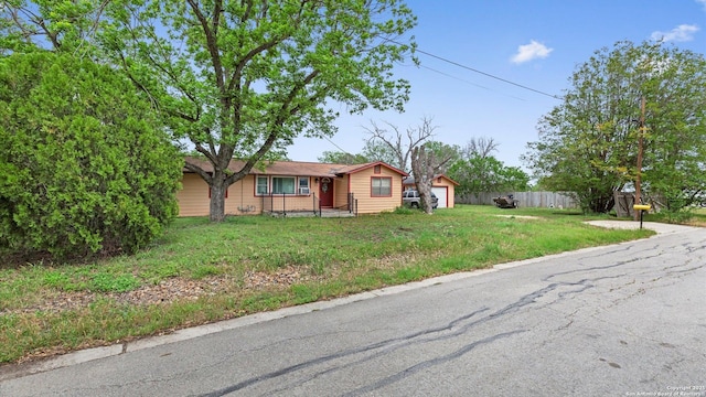 single story home with fence and a front lawn