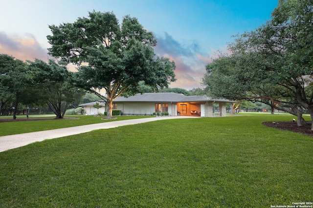 view of front of property with a front lawn and concrete driveway