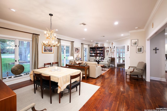dining room with ornamental molding, visible vents, plenty of natural light, and an inviting chandelier