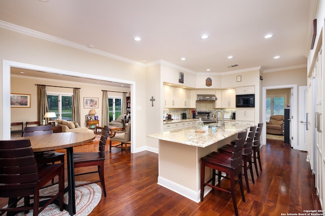 kitchen with recessed lighting, dark wood-style flooring, and black microwave