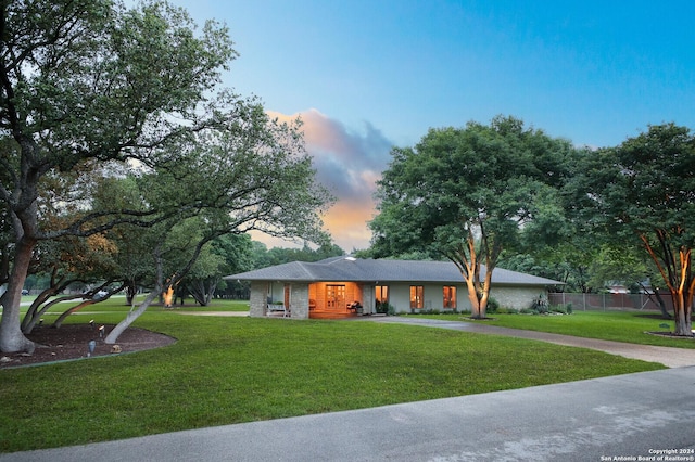 single story home featuring fence, driveway, and a front yard