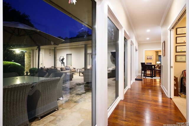 hall featuring crown molding, recessed lighting, and wood finished floors
