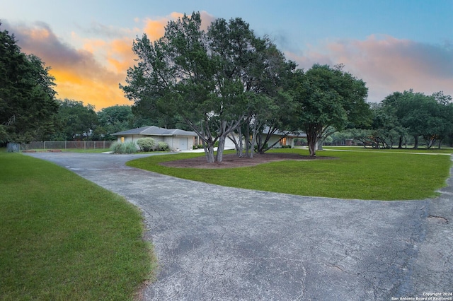 view of front of property with fence, driveway, and a front yard