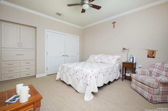 bedroom with ceiling fan, visible vents, a closet, ornamental molding, and light carpet