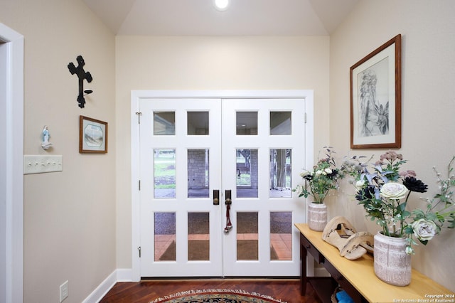 doorway featuring french doors, dark wood-style flooring, and baseboards
