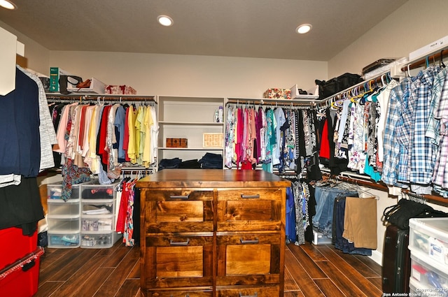 walk in closet with wood finish floors