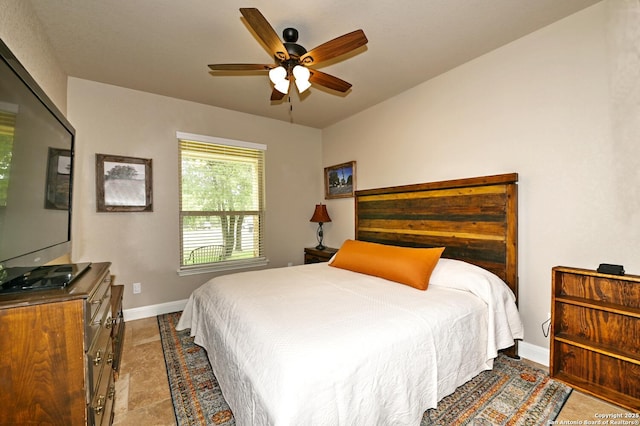 bedroom featuring baseboards and a ceiling fan
