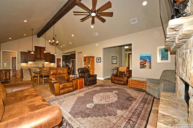 living area featuring visible vents, a fireplace, beam ceiling, high vaulted ceiling, and ceiling fan with notable chandelier