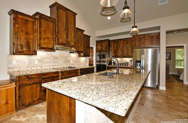 kitchen featuring backsplash, stainless steel appliances, a sink, lofted ceiling, and under cabinet range hood