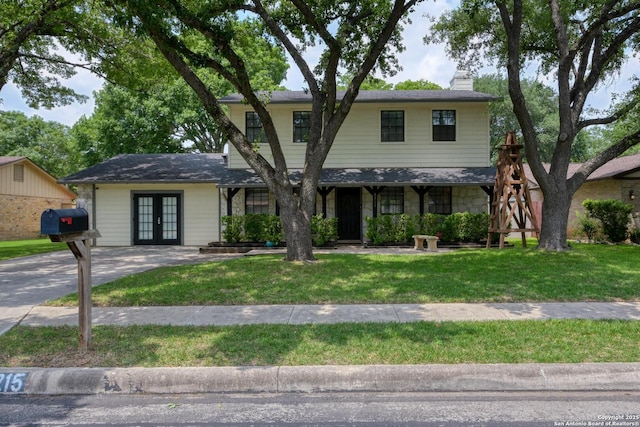 2215 Shady Rock Cir, San Antonio, TX 78231 - traditional-style house with french doors, a chimney, and a front yard