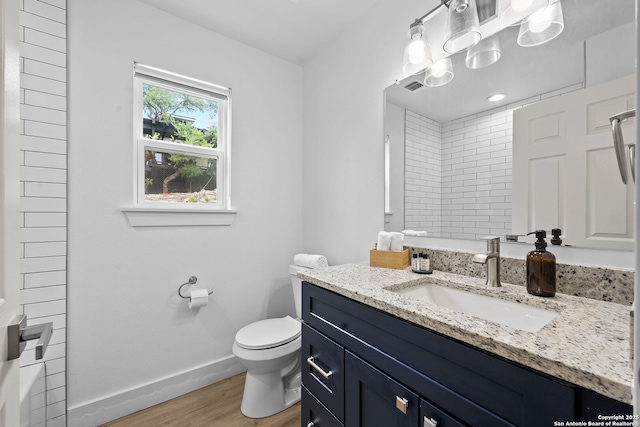 1050 Trail Pass Dr, Canyon Lake, TX 78133 - bathroom featuring walk in shower, wood finished floors, baseboards, vanity, and toilet