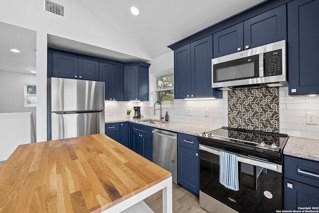 1050 Trail Pass Dr, Canyon Lake, TX 78133 - kitchen with blue cabinetry, appliances with stainless steel finishes, a sink, and visible vents