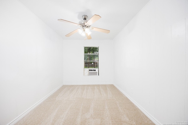 carpeted spare room with baseboards, ceiling fan, and cooling unit