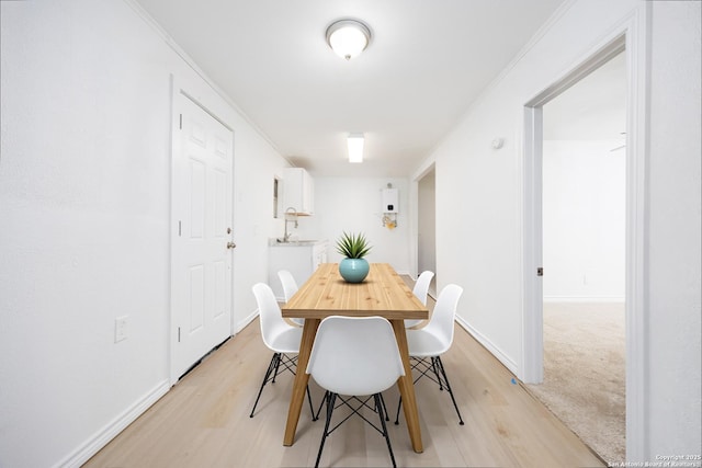 dining room featuring baseboards and light wood-type flooring