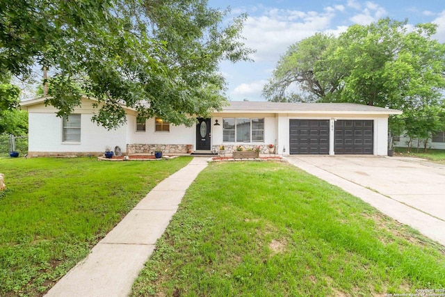 ranch-style house with fence, an attached garage, stucco siding, a front yard, and driveway