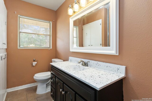 189 National, Universal City, TX 78148 - bathroom featuring toilet, tile patterned floors, baseboards, and vanity