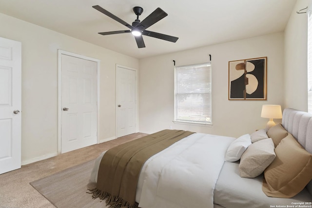 carpeted bedroom featuring a ceiling fan and baseboards