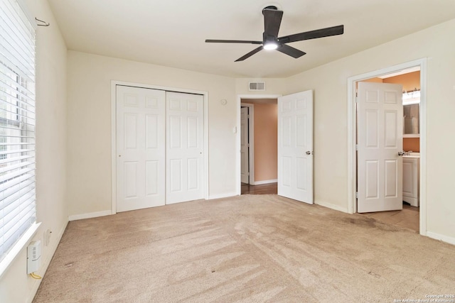 unfurnished bedroom featuring visible vents, a closet, baseboards, ceiling fan, and carpet