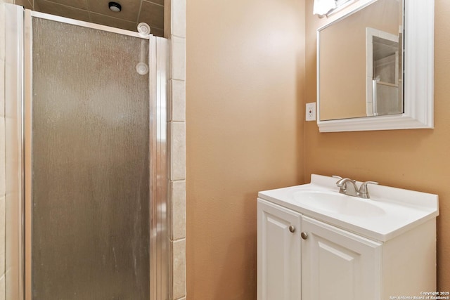 full bath featuring vanity and a shower stall