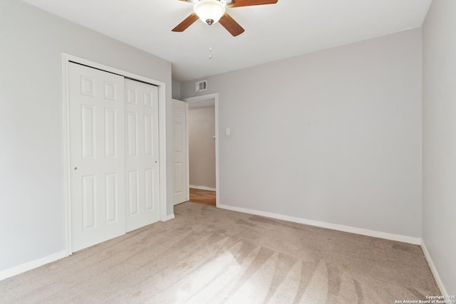 unfurnished bedroom with carpet floors, baseboards, a closet, and visible vents
