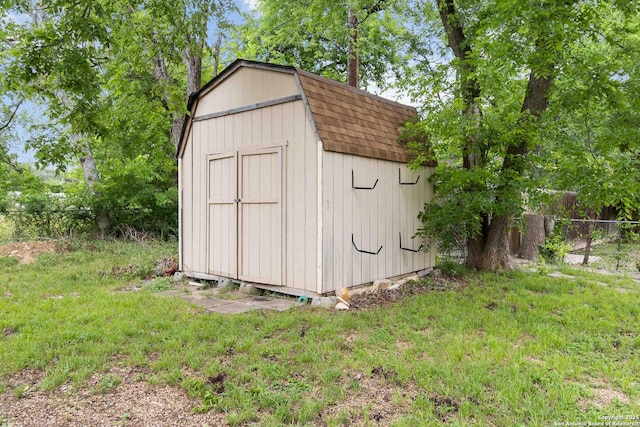 view of shed featuring fence