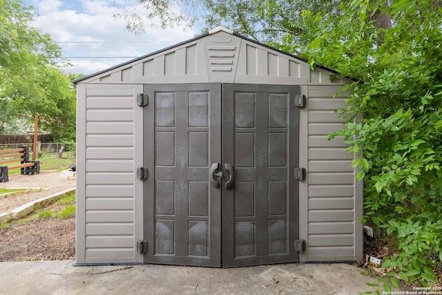 view of shed featuring fence