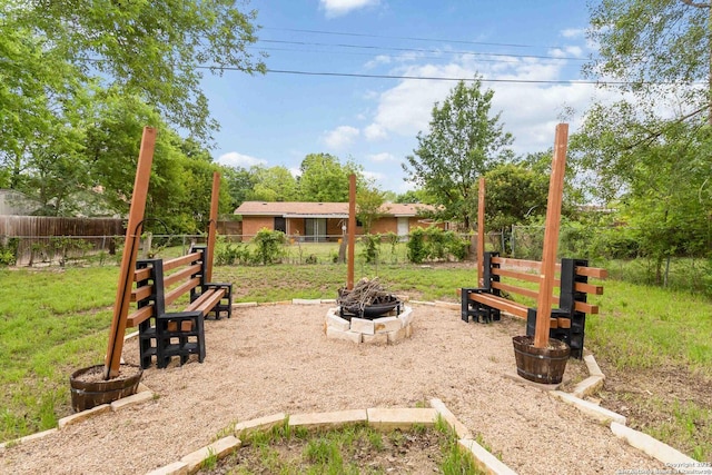 view of yard with fence private yard and a fire pit