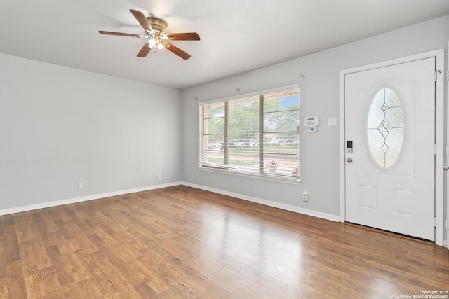 entrance foyer with baseboards, ceiling fan, and wood finished floors