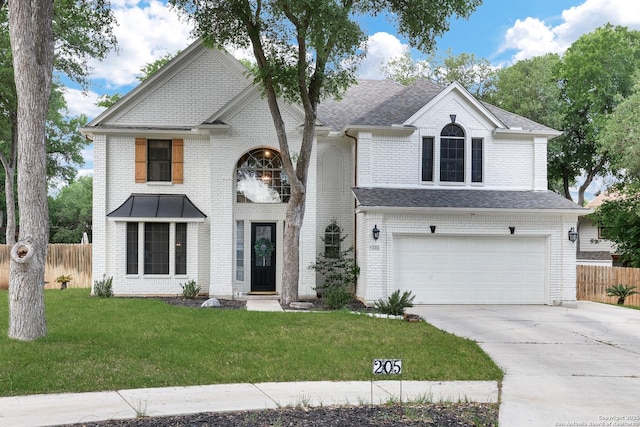 view of front of home with fence, concrete driveway, a front lawn, and a garage
